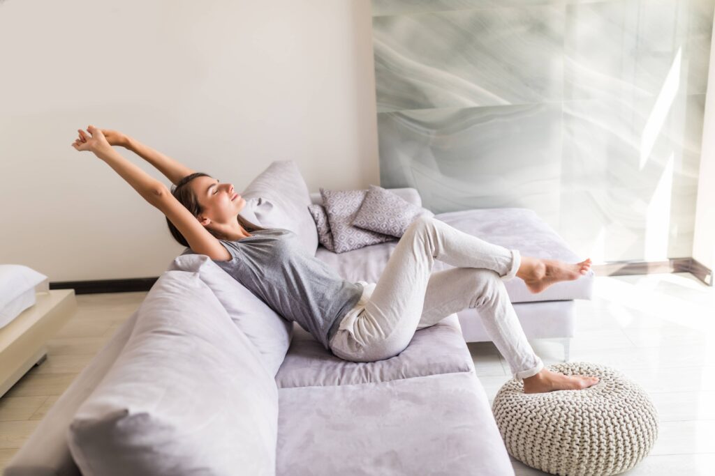 smiling young woman enjoying air purifier