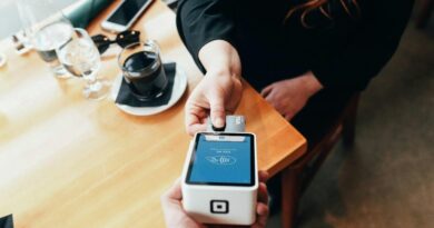 A person using a swipe machine.