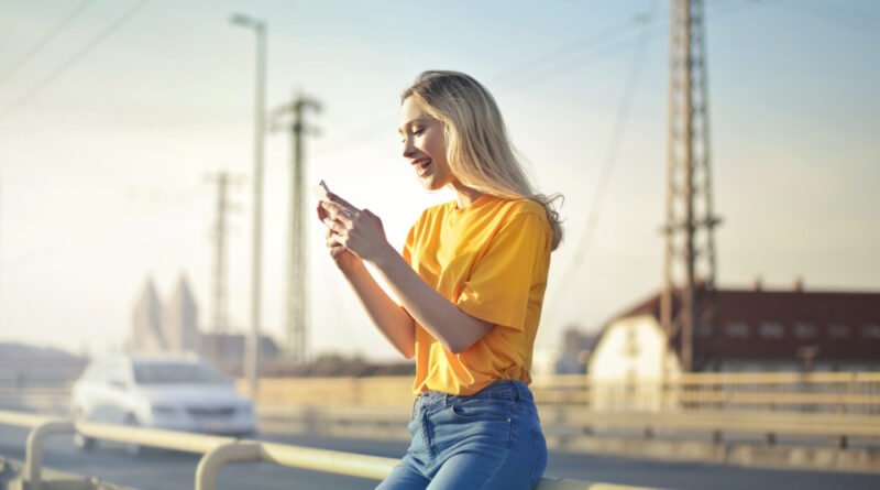 a girl standing and using mobile