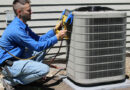 HVAC technician repairing an outdoor air conditioning unit using professional tools, ensuring efficient cooling system performance