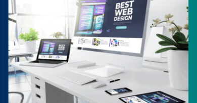 A modern workspace with a desktop computer, laptop, tablet, and smartphone displaying a "Best Web Design" website, emphasizing responsive design.